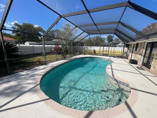 view of pool featuring a patio and glass enclosure