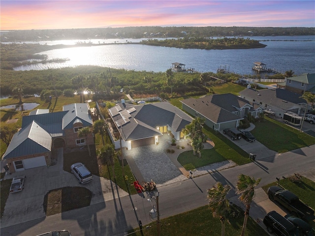 aerial view at dusk with a water view