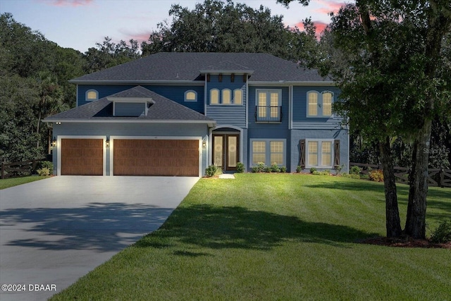 view of front facade with a garage and a lawn