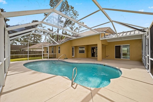 view of swimming pool with a patio area and glass enclosure