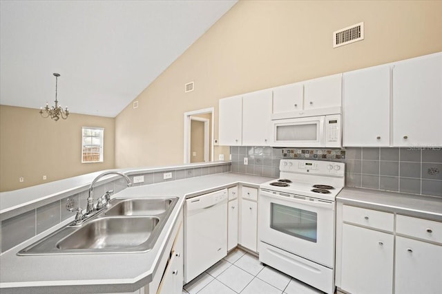 kitchen with white appliances, high vaulted ceiling, pendant lighting, and white cabinets