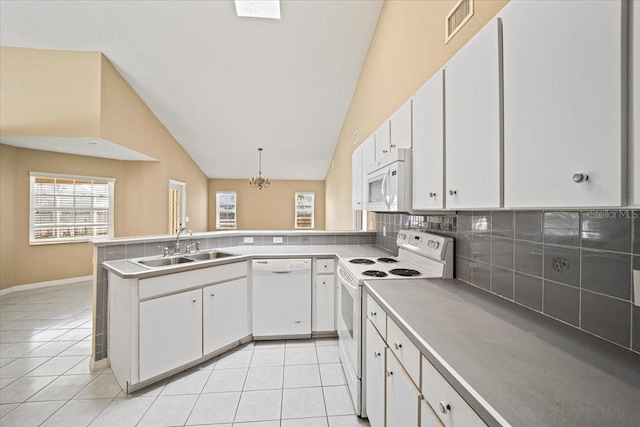 kitchen with white cabinets, light tile patterned floors, pendant lighting, sink, and white appliances