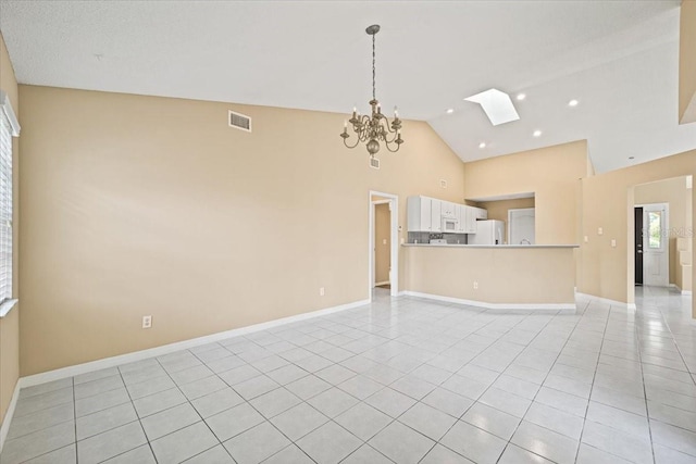 unfurnished living room featuring high vaulted ceiling, a notable chandelier, a skylight, and light tile patterned flooring