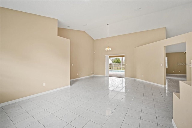 empty room featuring a chandelier, high vaulted ceiling, and light tile patterned floors