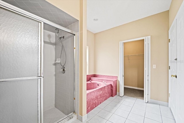 bathroom with independent shower and bath and tile patterned flooring