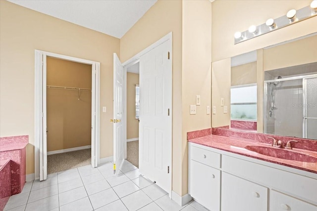 bathroom featuring vanity, tile patterned floors, and a shower with door