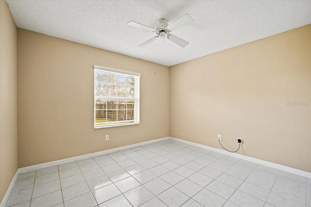 empty room featuring ceiling fan, a textured ceiling, and light tile patterned floors