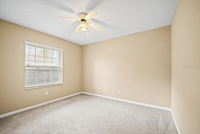 carpeted empty room with a textured ceiling and ceiling fan