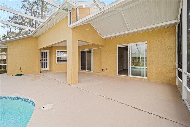 back of property with a patio and a lanai