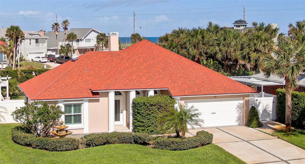 view of front of property with a front lawn and a garage