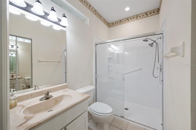 bathroom with toilet, tile patterned flooring, vanity, and a shower with door