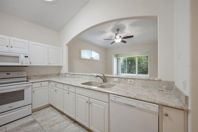 kitchen featuring white cabinets, ceiling fan, light stone countertops, sink, and white appliances