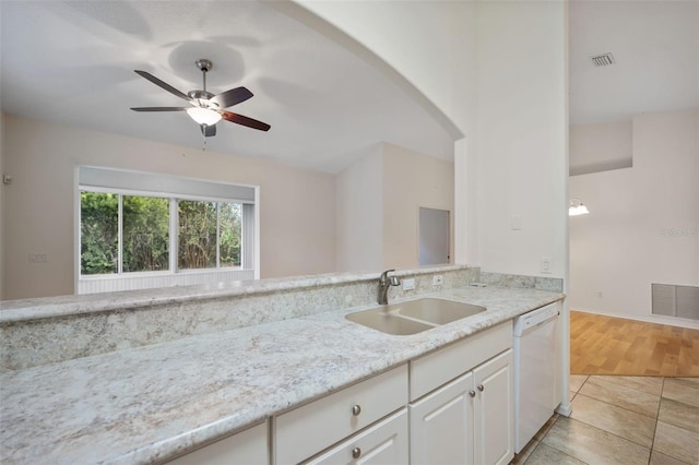 kitchen with light stone countertops, sink, white dishwasher, white cabinetry, and ceiling fan