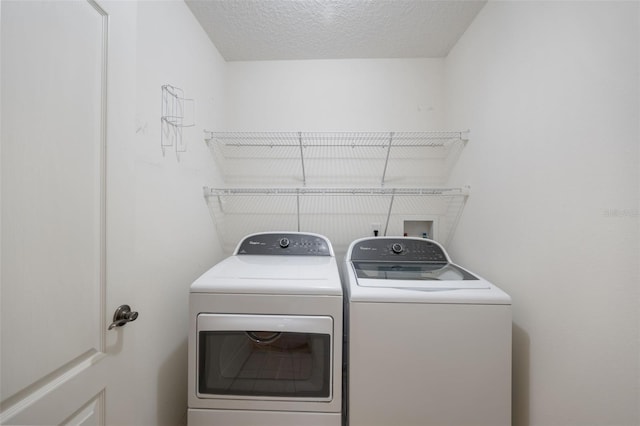 laundry area featuring a textured ceiling and separate washer and dryer