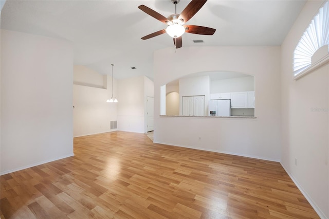 unfurnished living room featuring light hardwood / wood-style floors, ceiling fan, and vaulted ceiling