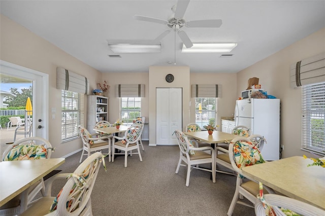 dining space featuring ceiling fan and carpet floors