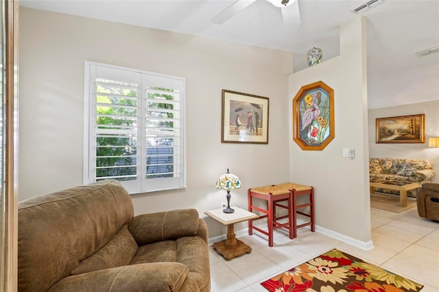 tiled living room featuring ceiling fan