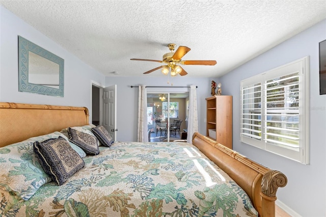 bedroom with ceiling fan, a textured ceiling, and access to exterior