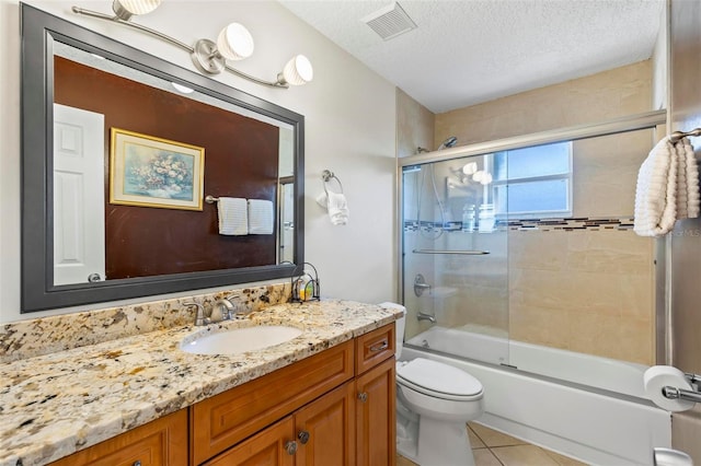 full bathroom with toilet, tile patterned flooring, vanity, a textured ceiling, and shower / bath combination with glass door