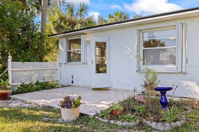 property entrance featuring a patio area