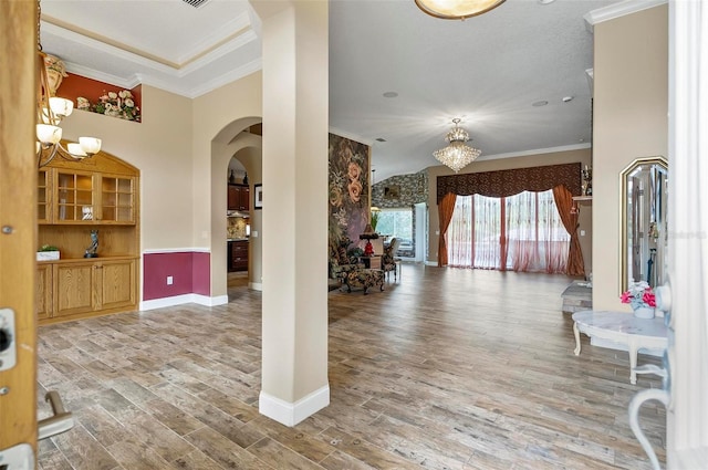 interior space with crown molding, hardwood / wood-style flooring, and a chandelier