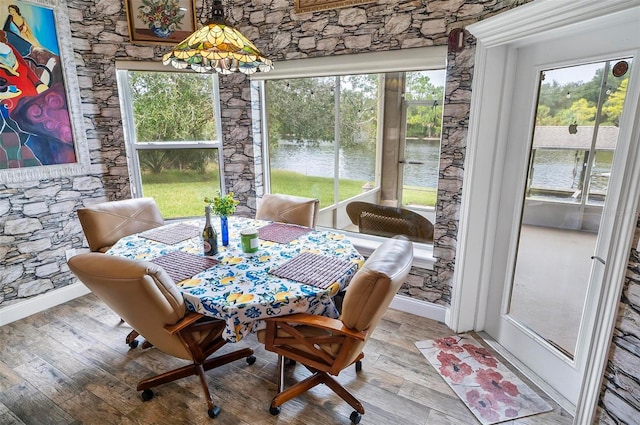 dining space with wood-type flooring and plenty of natural light