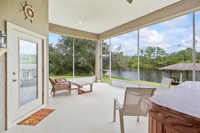 sunroom / solarium featuring a water view and plenty of natural light