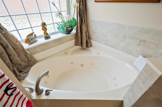 bathroom with a relaxing tiled tub