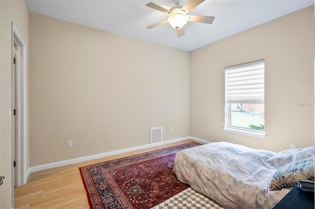 bedroom with light wood-type flooring and ceiling fan