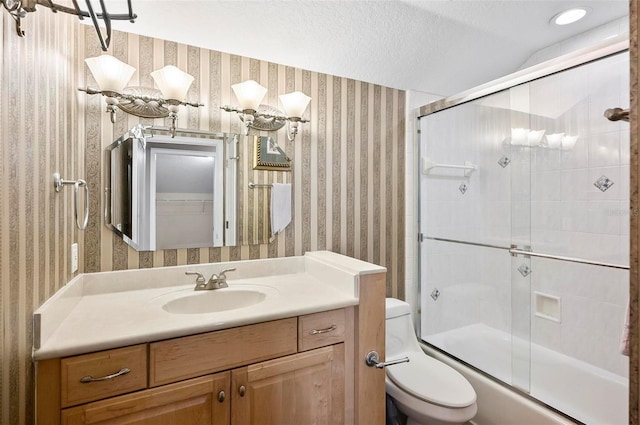 full bathroom featuring a textured ceiling, shower / bath combination with glass door, vaulted ceiling, toilet, and vanity