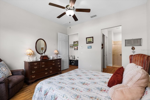 bedroom featuring ensuite bath, light wood-type flooring, and ceiling fan