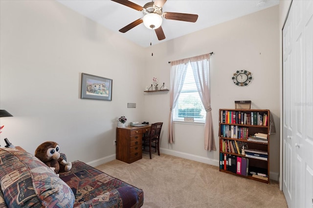 living area with ceiling fan and light carpet