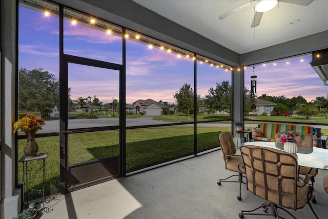 sunroom featuring ceiling fan