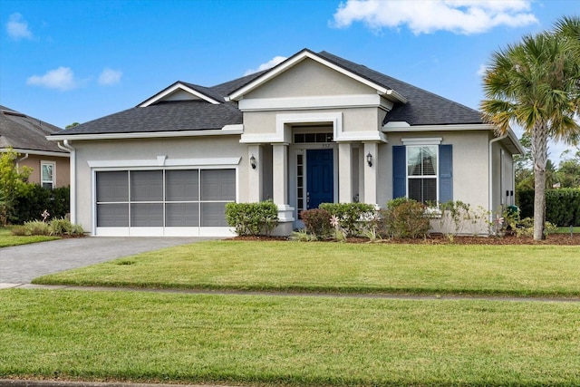 view of front of property featuring a front lawn and a garage