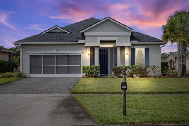 view of front of property with a yard and a garage