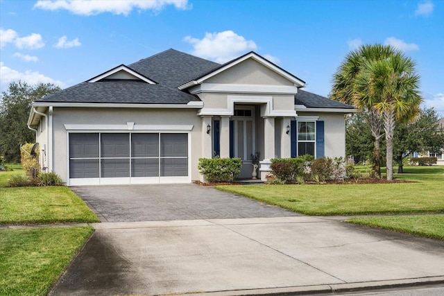 view of front of property with a front yard and a garage