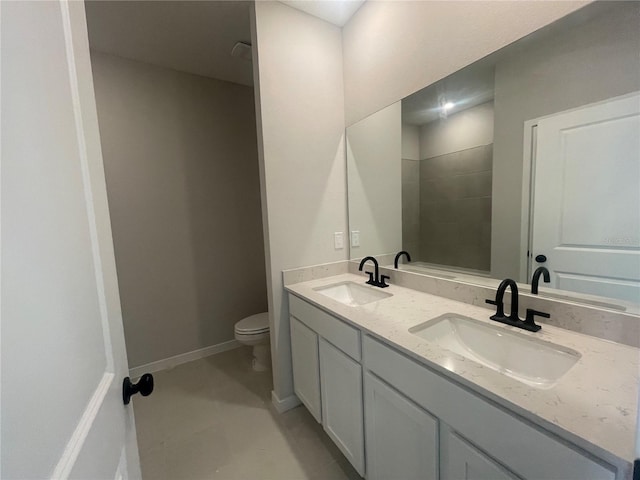 bathroom featuring vanity, tile patterned floors, and toilet