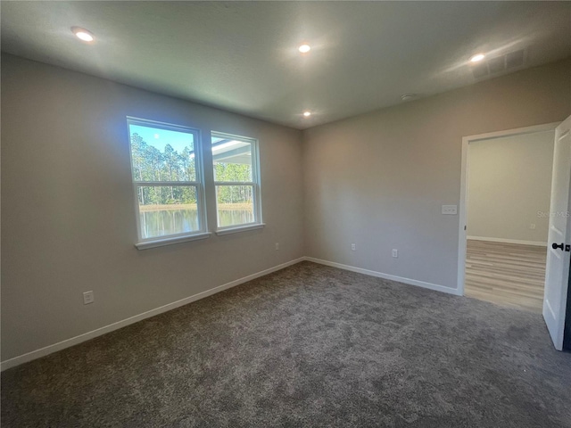 spare room featuring carpet