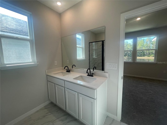 bathroom with vanity and a shower with shower door