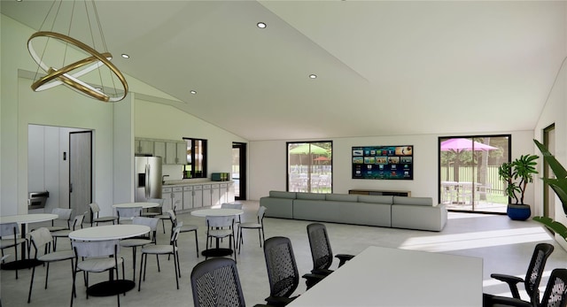 dining space featuring high vaulted ceiling