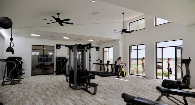 gym with a towering ceiling and ceiling fan