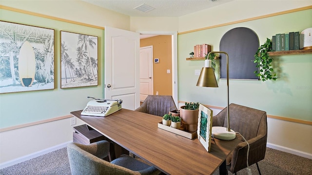 home office with carpet and a textured ceiling