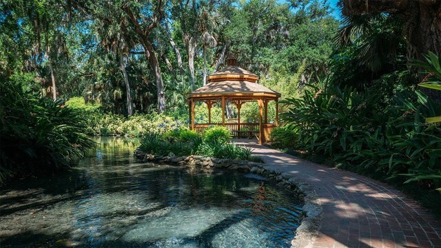 view of pool featuring a gazebo and a water view