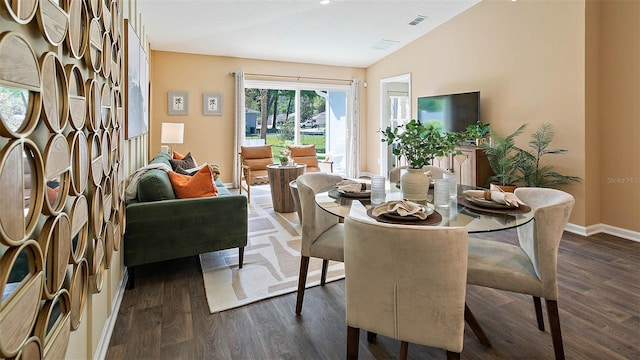 dining area with vaulted ceiling and dark hardwood / wood-style flooring