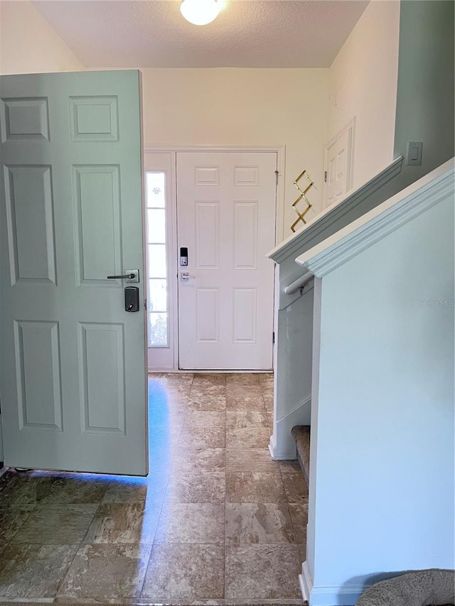 foyer with a textured ceiling