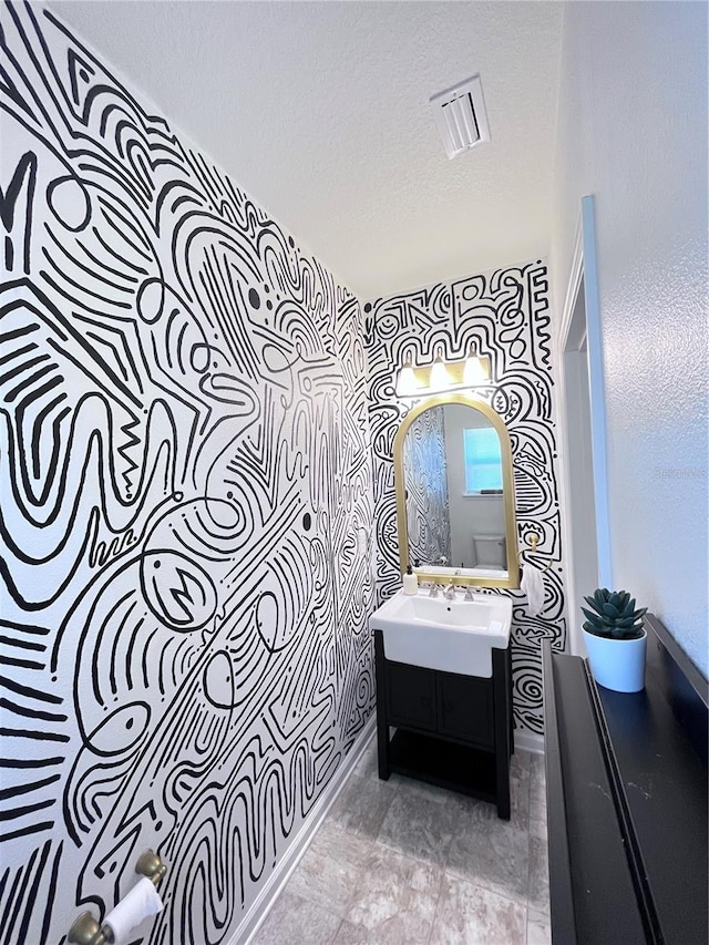 bathroom with vanity and a textured ceiling