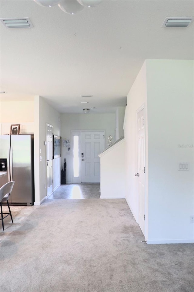 interior space featuring light colored carpet