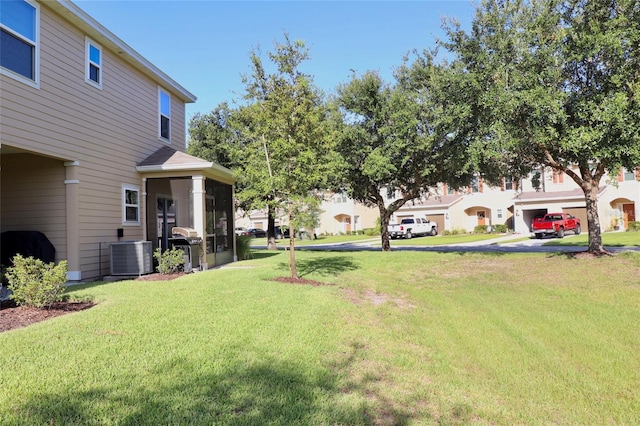 view of yard with a garage and cooling unit