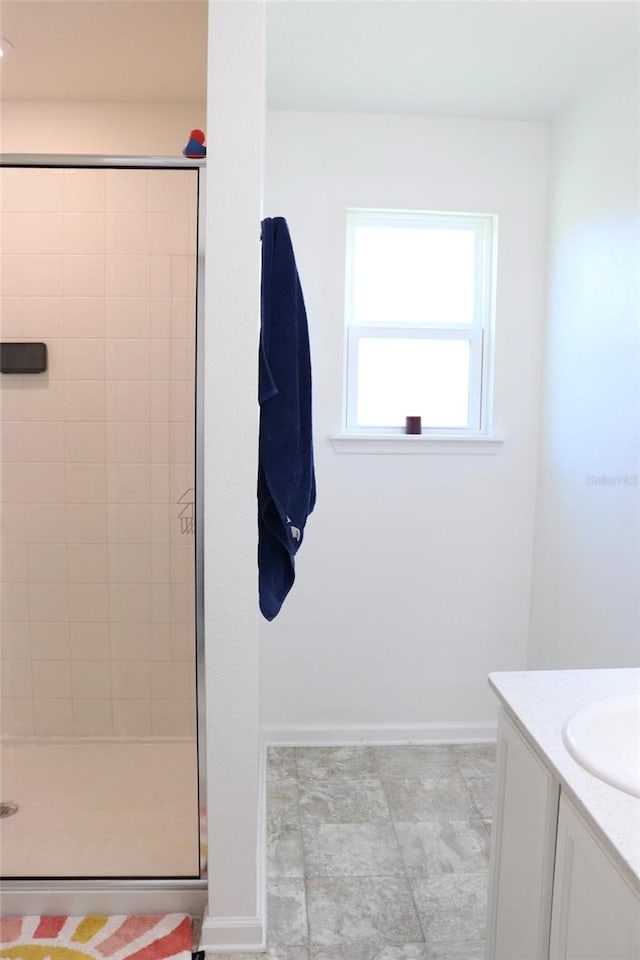 bathroom with vanity and a tile shower