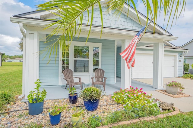 entrance to property with a garage and a porch